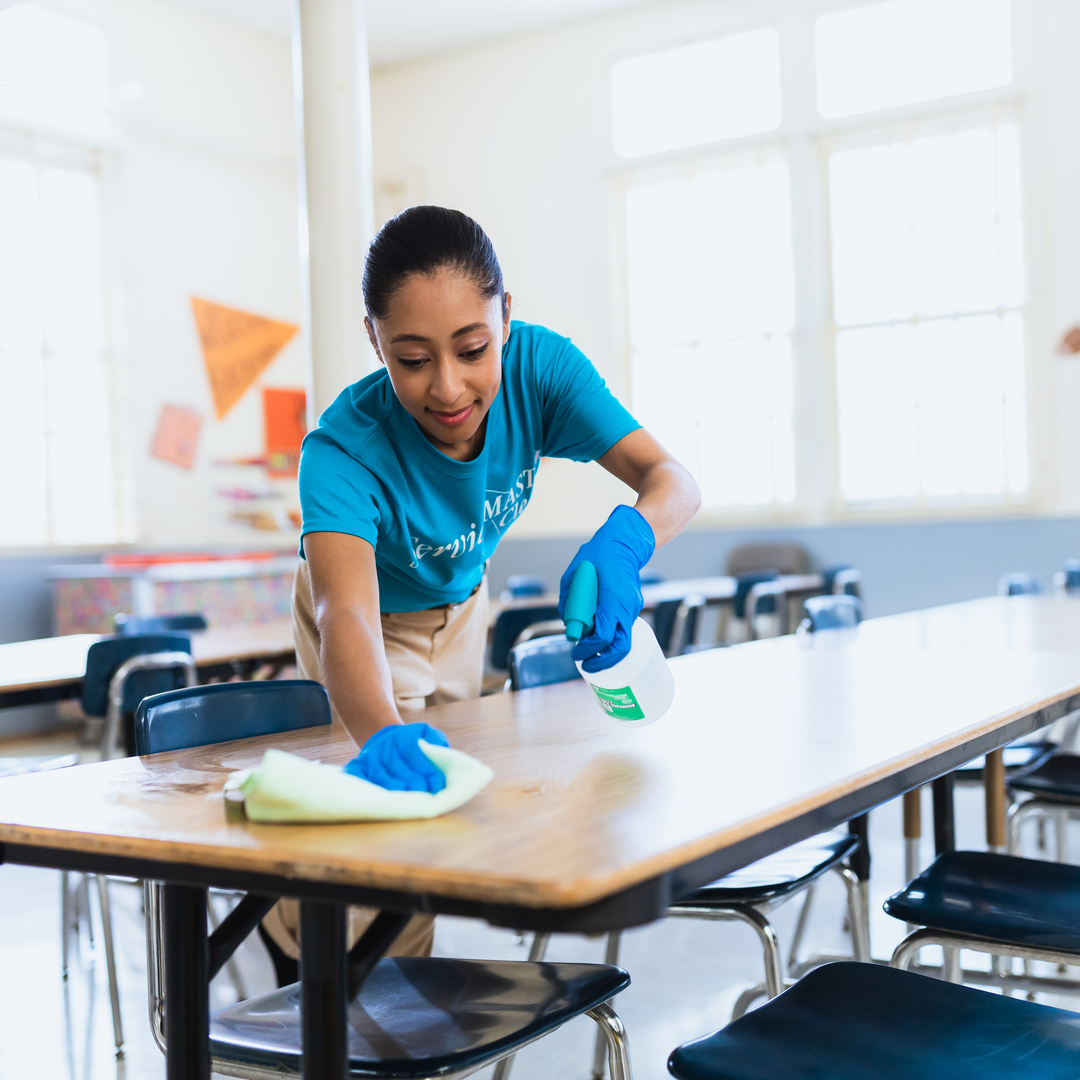 woman wiping down table