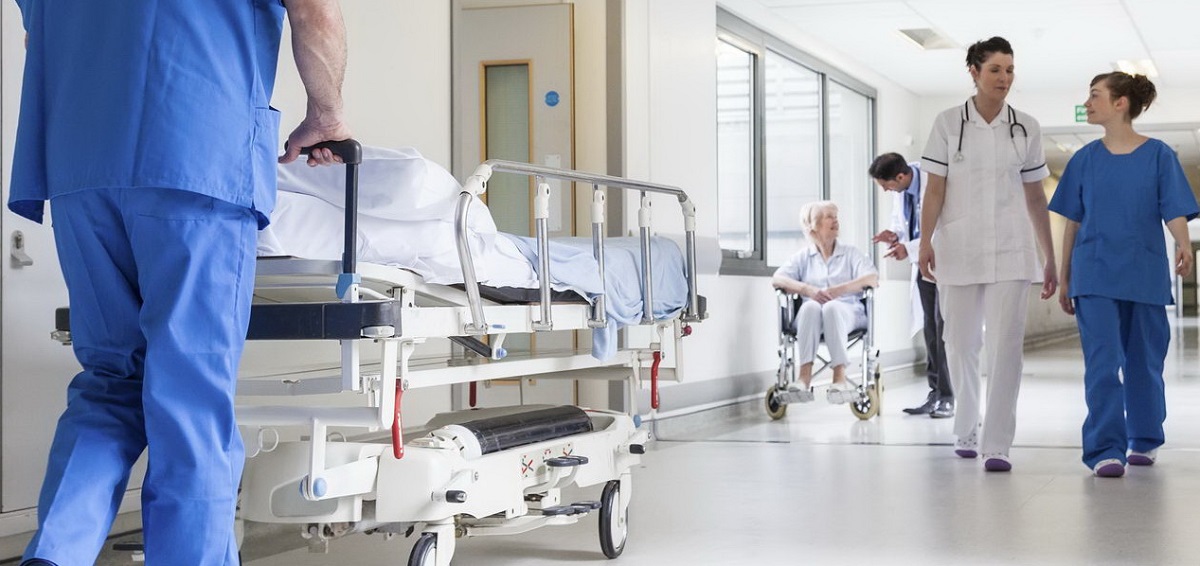 Hospital hallway with stretcher and people