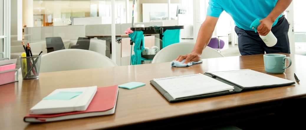 man cleaning desk