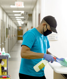 Man Spraying Cleaner on Counter Surface