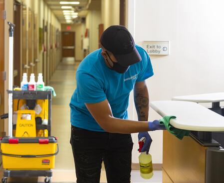 man wiping a countertop
